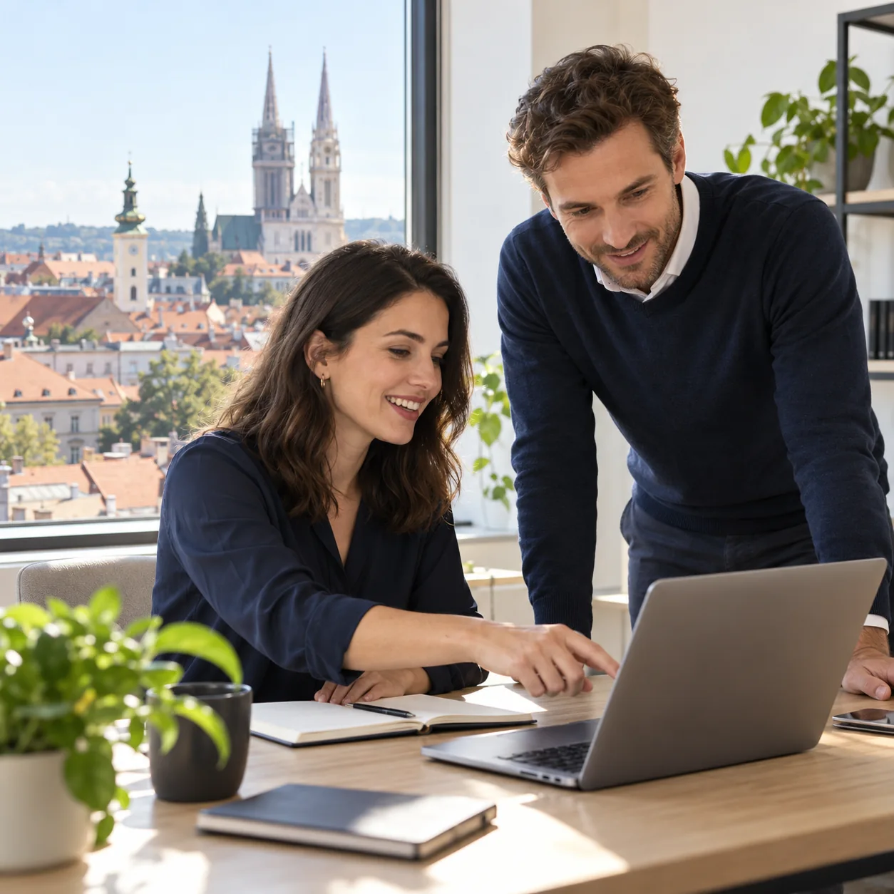 Two professionals discussing a hiring plan in a Zagreb office
