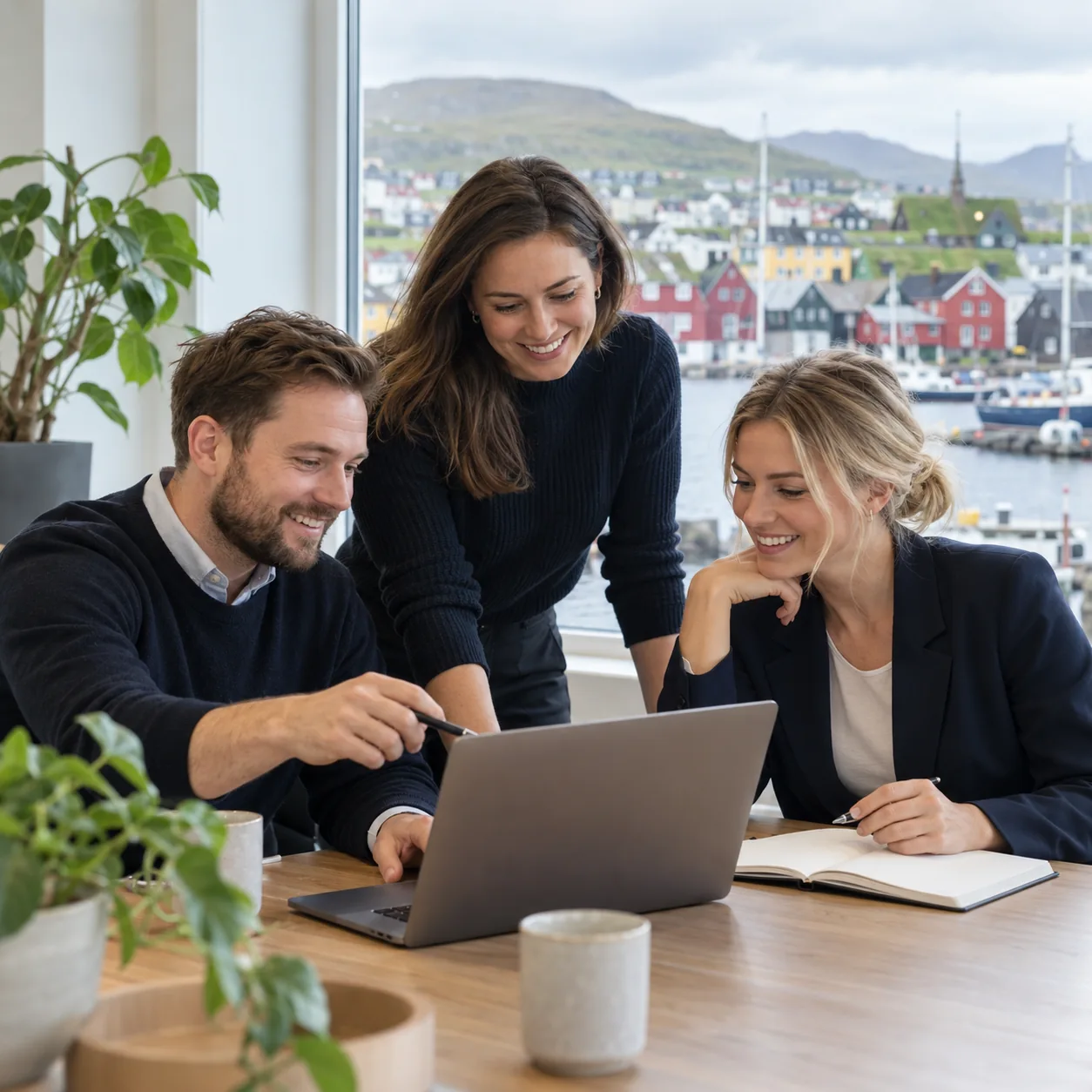 Three professionals discussing a hiring plan in a Tórshavn office