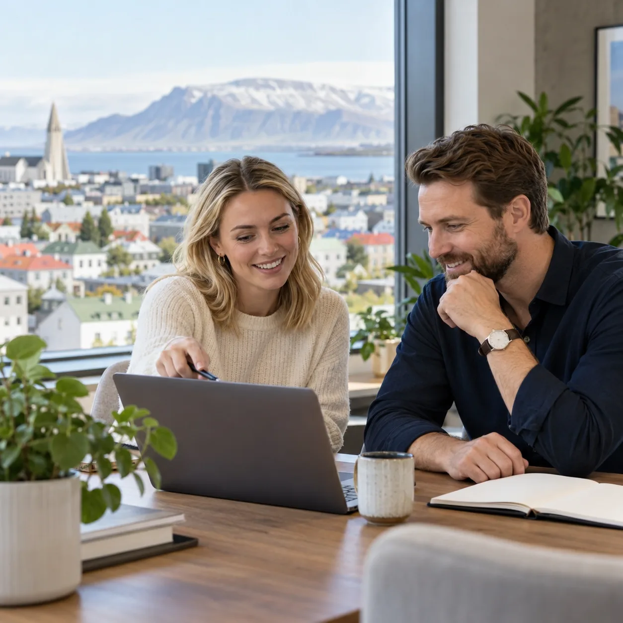 Two professionals discussing a hiring plan in an office in Reykjavík