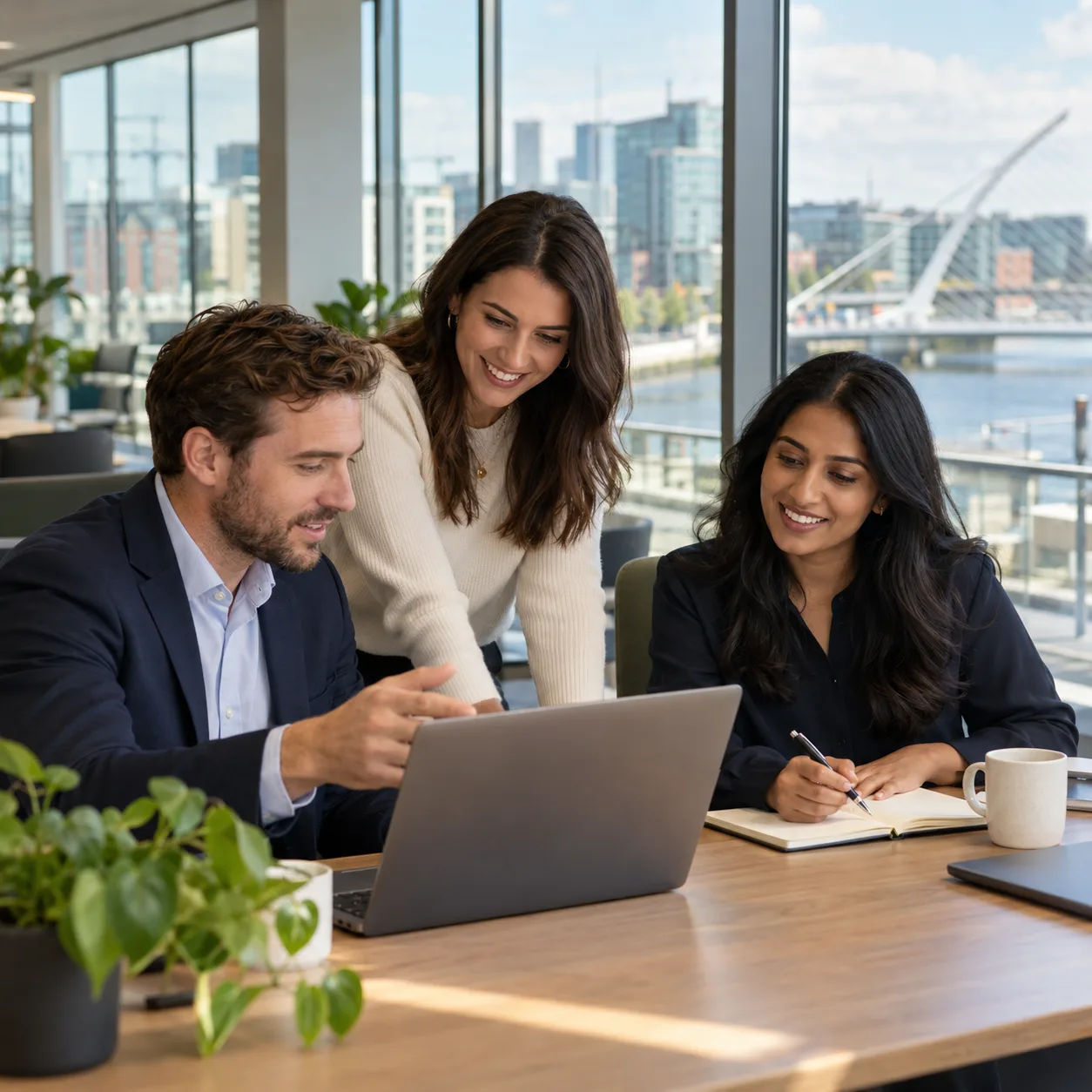 Three professionals discussing a hiring plan in an office in Dublin