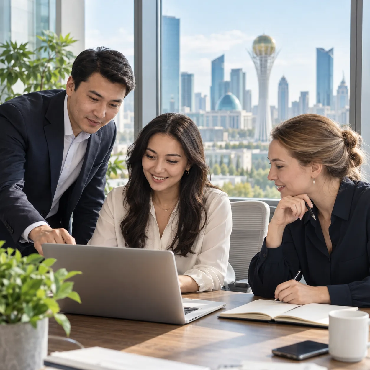 Three professionals discussing a hiring plan in an office in Astana