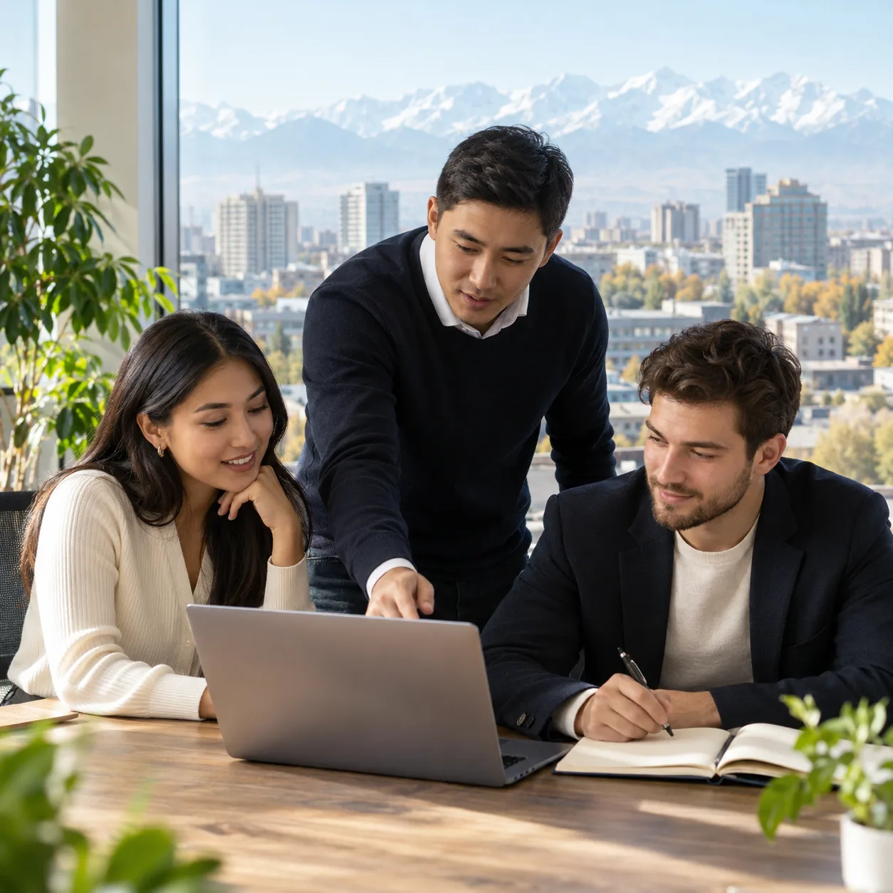 Three professionals discussing a hiring plan in an office in Bishkek