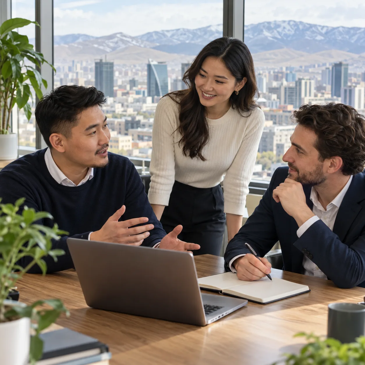 Three professionals discussing a hiring plan in an office in Ulaanbaatar