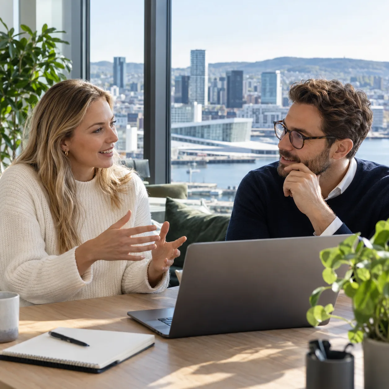 Two professionals discussing a hiring plan in an office in Oslo