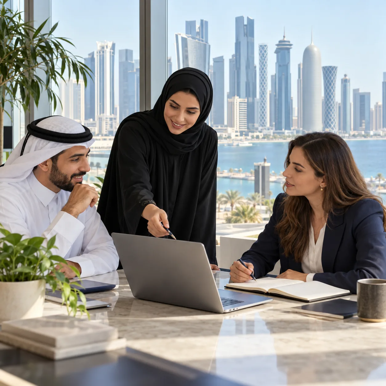 Three professionals discussing a hiring plan in an office in Doha