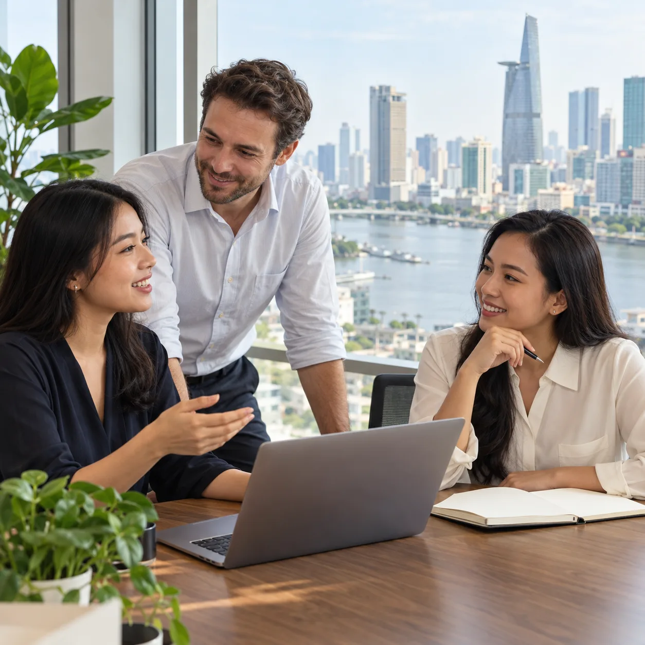 Three professionals discussing a hiring plan in an office in Ho Chi Minh City